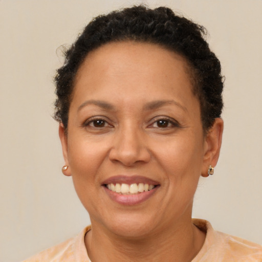 Joyful black adult female with short  brown hair and brown eyes