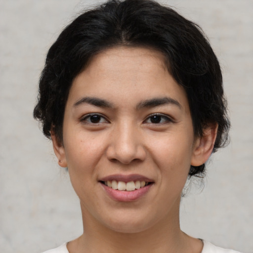 Joyful asian young-adult female with short  brown hair and brown eyes
