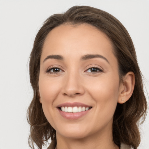 Joyful white young-adult female with medium  brown hair and brown eyes