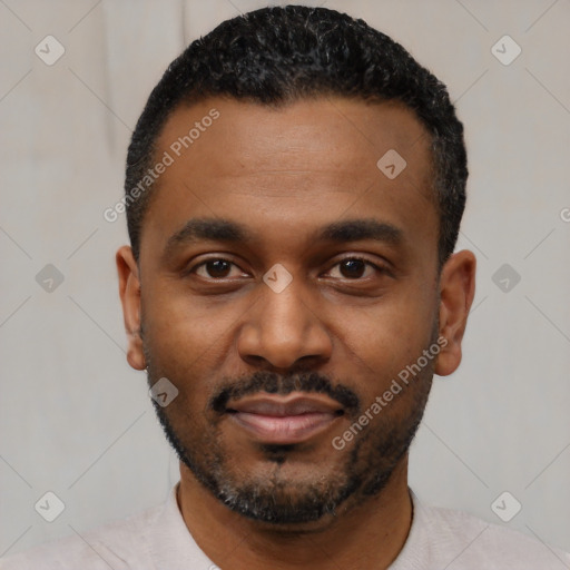 Joyful black young-adult male with short  black hair and brown eyes