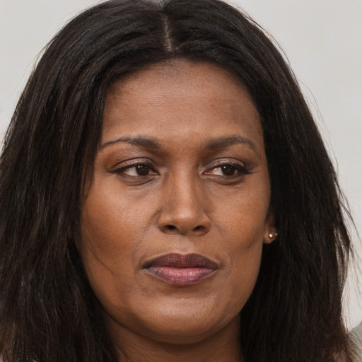 Joyful white adult female with long  brown hair and brown eyes