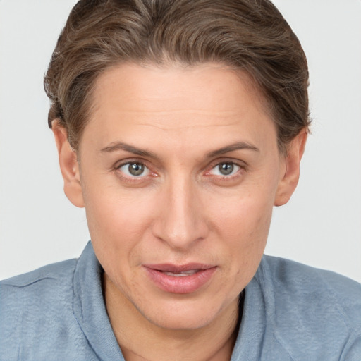 Joyful white adult female with short  brown hair and brown eyes