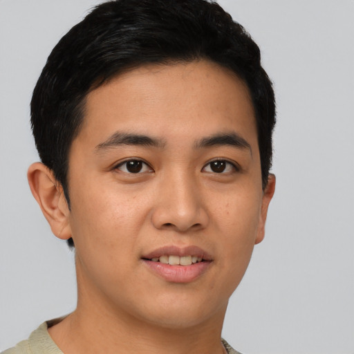 Joyful asian young-adult male with short  brown hair and brown eyes