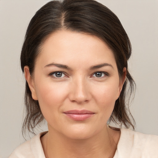 Joyful white young-adult female with medium  brown hair and brown eyes