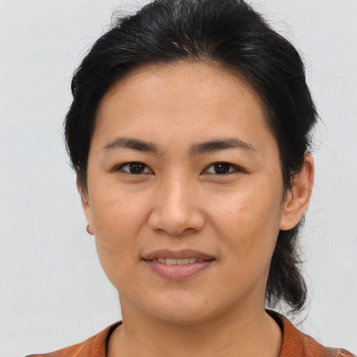 Joyful asian young-adult female with short  brown hair and brown eyes