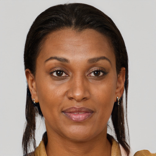 Joyful black adult female with medium  brown hair and brown eyes