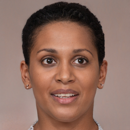 Joyful black young-adult female with short  brown hair and brown eyes