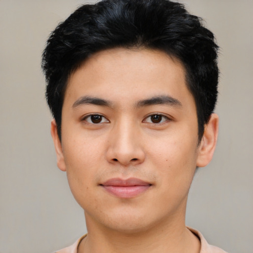 Joyful asian young-adult male with short  black hair and brown eyes