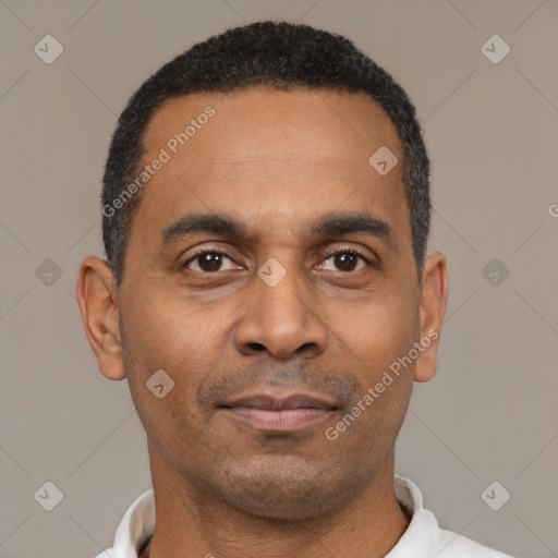 Joyful latino adult male with short  black hair and brown eyes