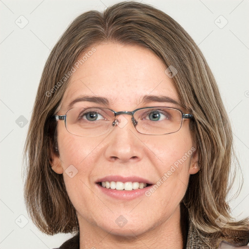 Joyful white adult female with medium  brown hair and blue eyes