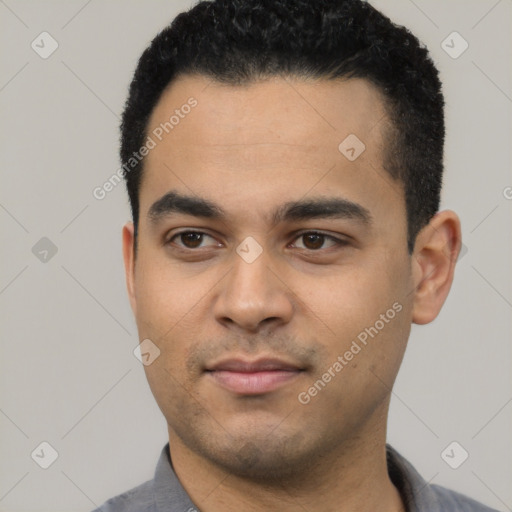 Joyful latino young-adult male with short  black hair and brown eyes