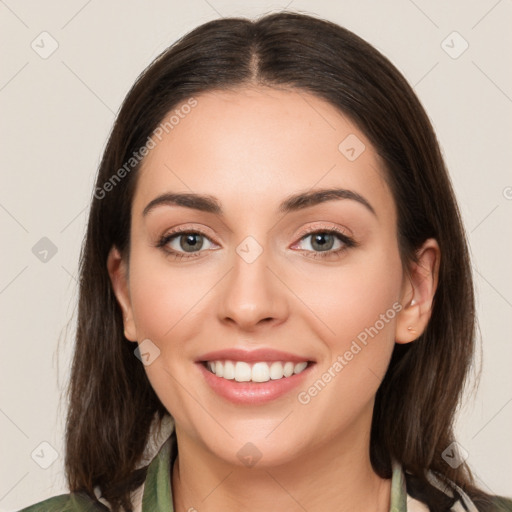 Joyful white young-adult female with medium  brown hair and green eyes