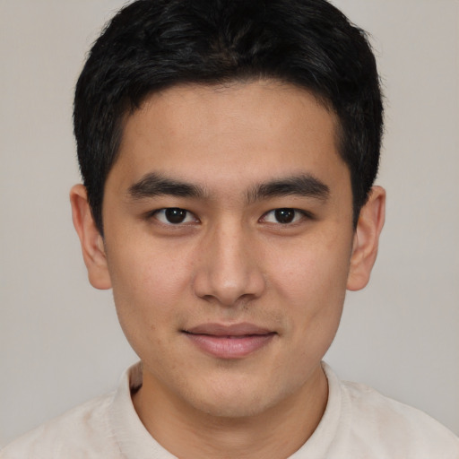 Joyful asian young-adult male with short  brown hair and brown eyes