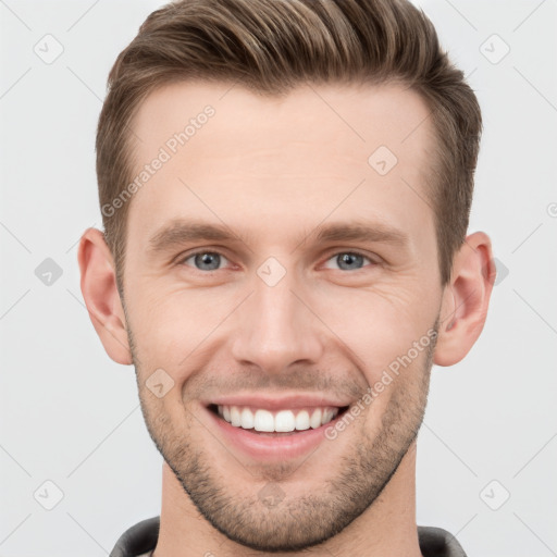 Joyful white young-adult male with short  brown hair and grey eyes