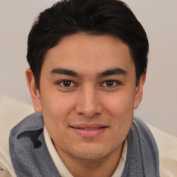 Joyful latino young-adult male with short  brown hair and brown eyes