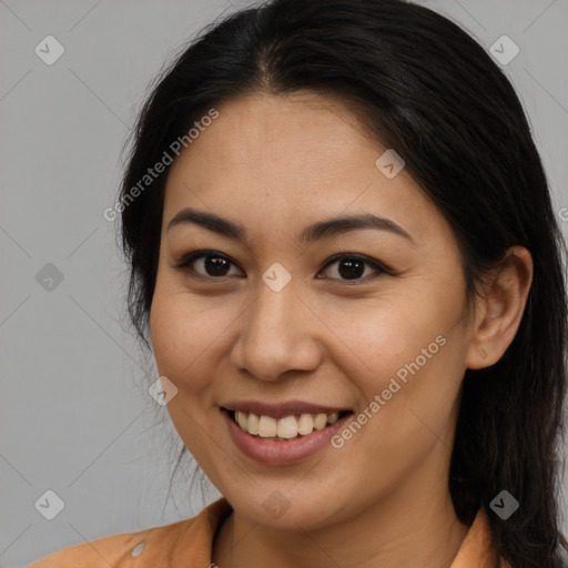 Joyful latino young-adult female with long  brown hair and brown eyes