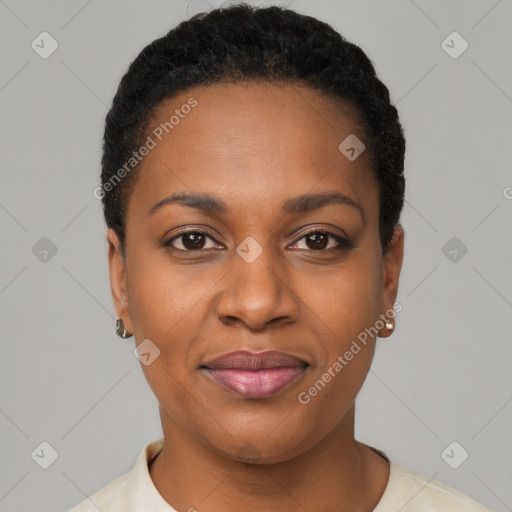 Joyful black young-adult female with short  black hair and brown eyes