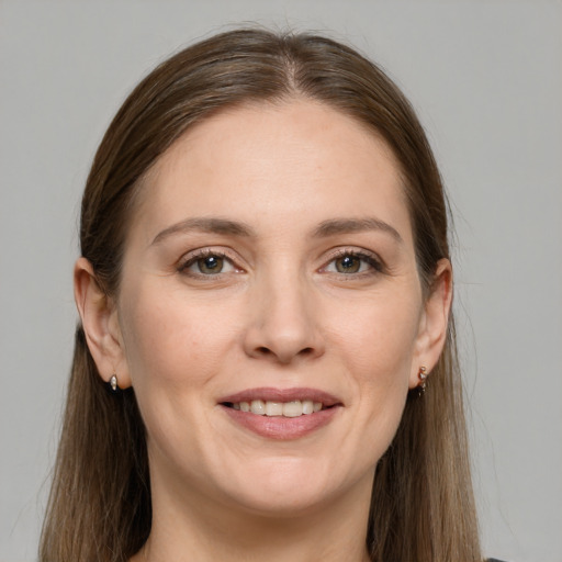 Joyful white young-adult female with long  brown hair and grey eyes