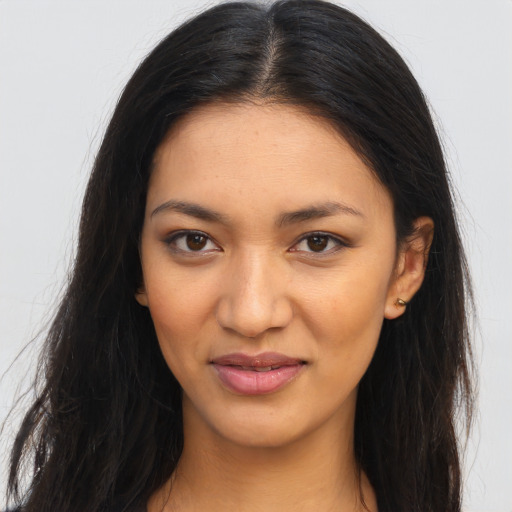 Joyful latino young-adult female with long  brown hair and brown eyes