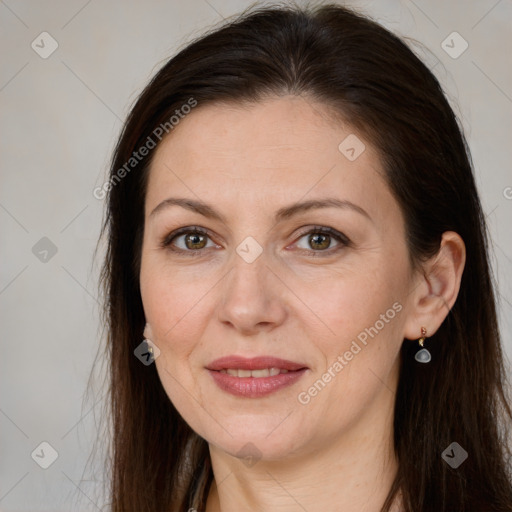 Joyful white adult female with long  brown hair and brown eyes