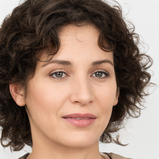 Joyful white young-adult female with medium  brown hair and green eyes