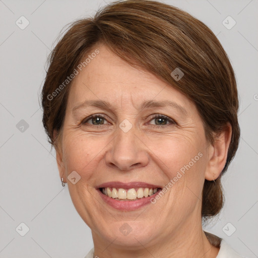 Joyful white adult female with medium  brown hair and grey eyes