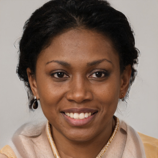 Joyful latino young-adult female with short  brown hair and brown eyes