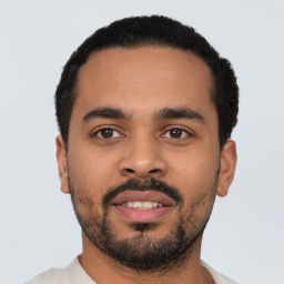 Neutral latino young-adult male with short  black hair and brown eyes