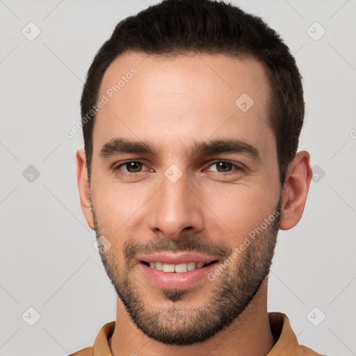 Joyful white young-adult male with short  brown hair and brown eyes