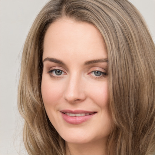 Joyful white young-adult female with long  brown hair and green eyes