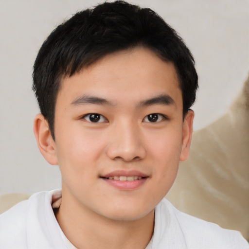 Joyful asian child male with short  black hair and brown eyes