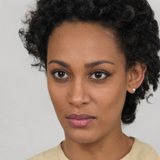 Neutral black young-adult female with short  brown hair and brown eyes