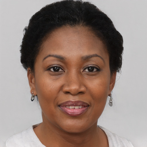 Joyful black adult female with short  brown hair and brown eyes