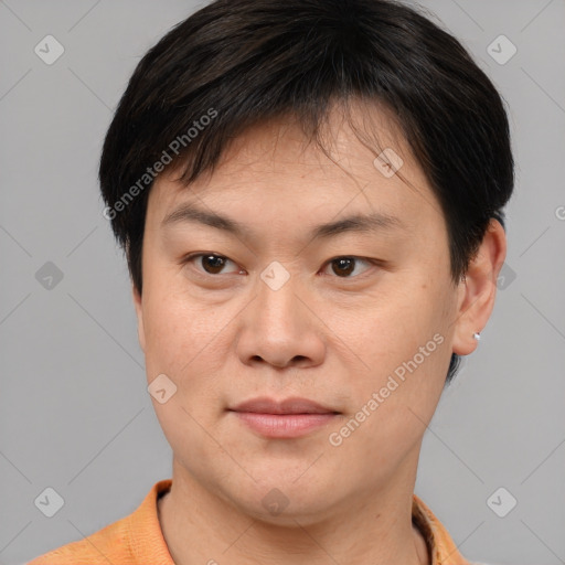 Joyful asian young-adult male with short  brown hair and brown eyes