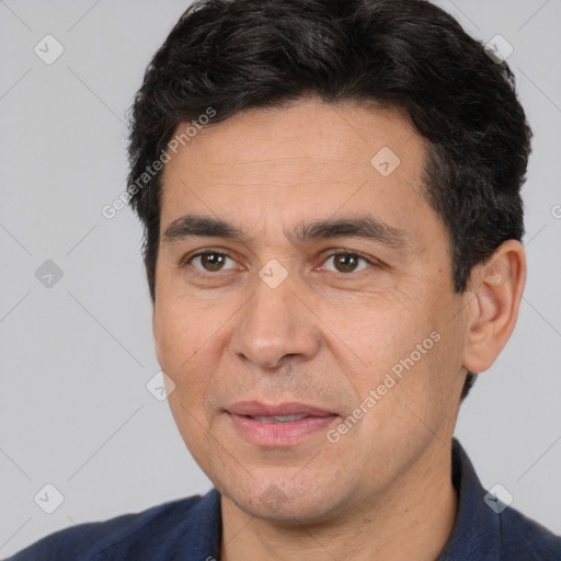 Joyful white adult male with short  black hair and brown eyes