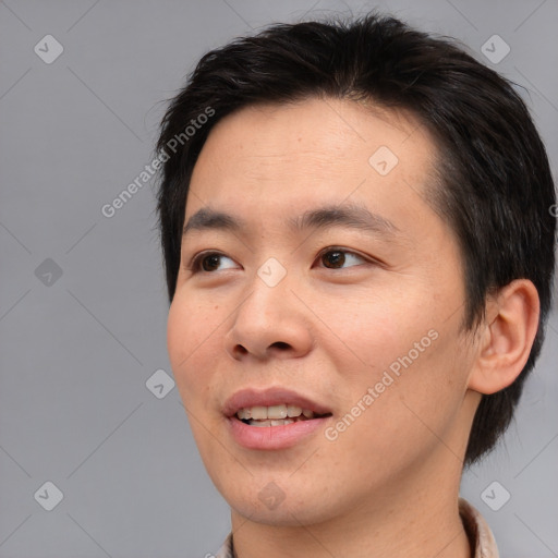 Joyful asian young-adult male with short  brown hair and brown eyes