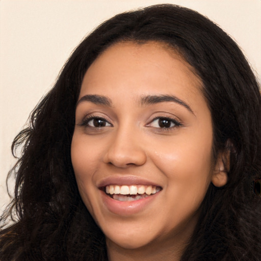 Joyful latino young-adult female with long  black hair and brown eyes