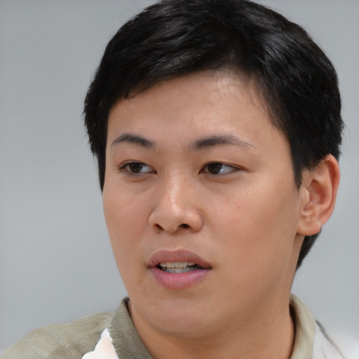 Joyful asian young-adult female with short  brown hair and brown eyes