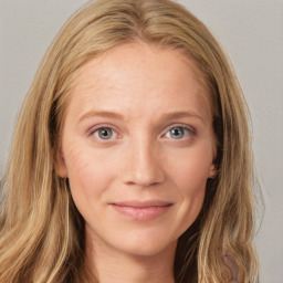 Joyful white young-adult female with long  brown hair and blue eyes