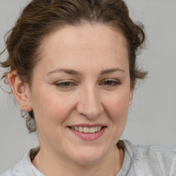 Joyful white adult female with medium  brown hair and brown eyes