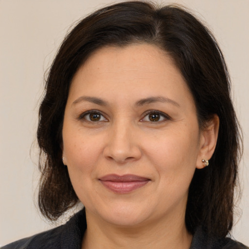 Joyful white adult female with medium  brown hair and brown eyes