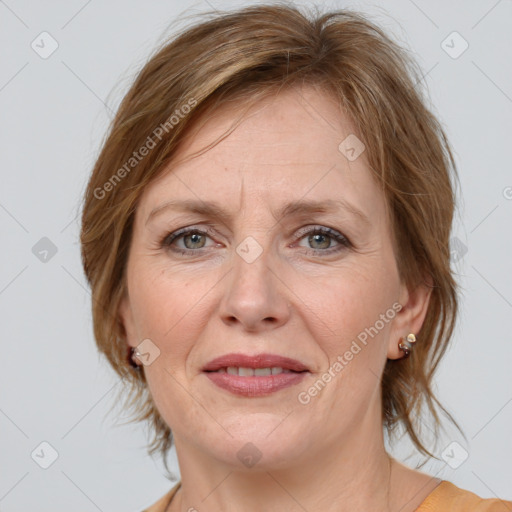 Joyful white adult female with medium  brown hair and grey eyes