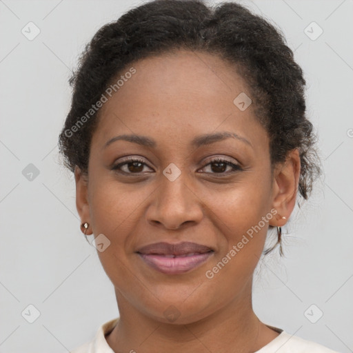 Joyful black adult female with short  brown hair and brown eyes