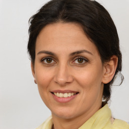 Joyful white adult female with medium  brown hair and brown eyes