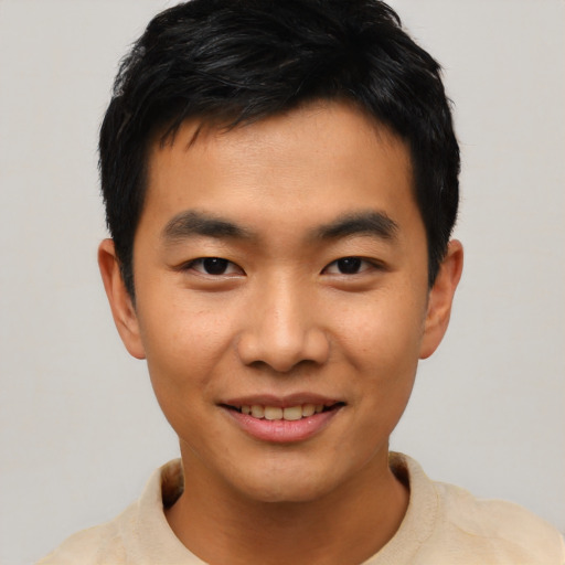 Joyful asian young-adult male with short  black hair and brown eyes