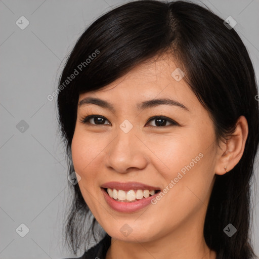 Joyful asian young-adult female with long  brown hair and brown eyes