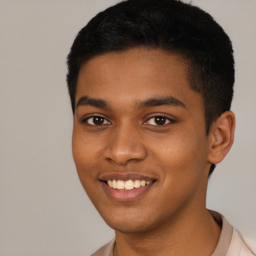 Joyful black young-adult male with short  black hair and brown eyes