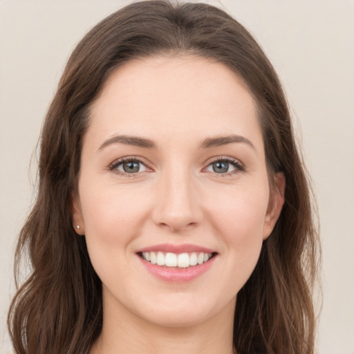 Joyful white young-adult female with long  brown hair and grey eyes