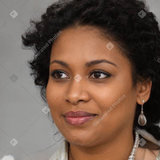 Joyful black young-adult female with long  black hair and brown eyes