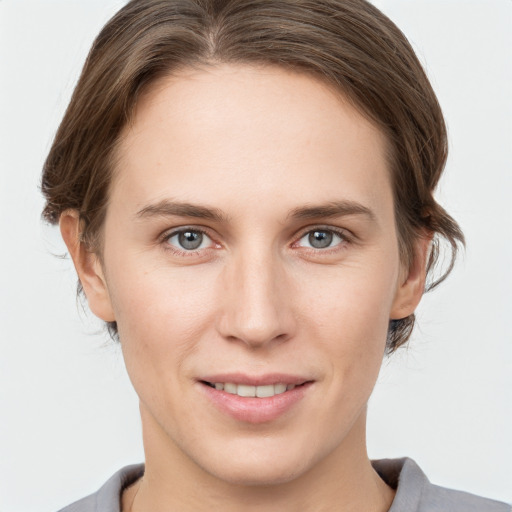 Joyful white young-adult female with medium  brown hair and grey eyes